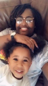 Nanny Amber with a smiling girl.