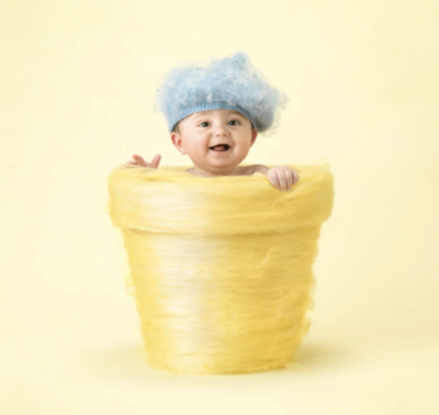 anne geddes photo of a baby inside of a yarn flower pot