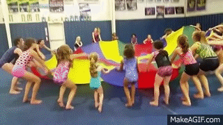 kids playing with a gymnastics parachute