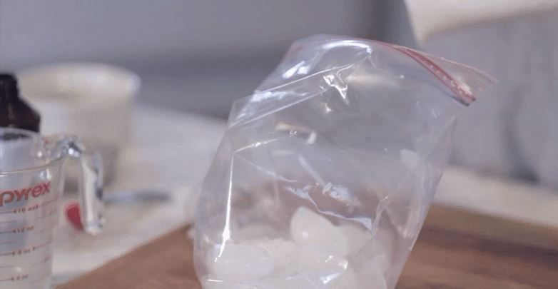 a man fills a bag with ice in order to make homemade ice cream