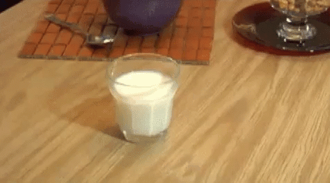 a gif of milk spilling on a table
