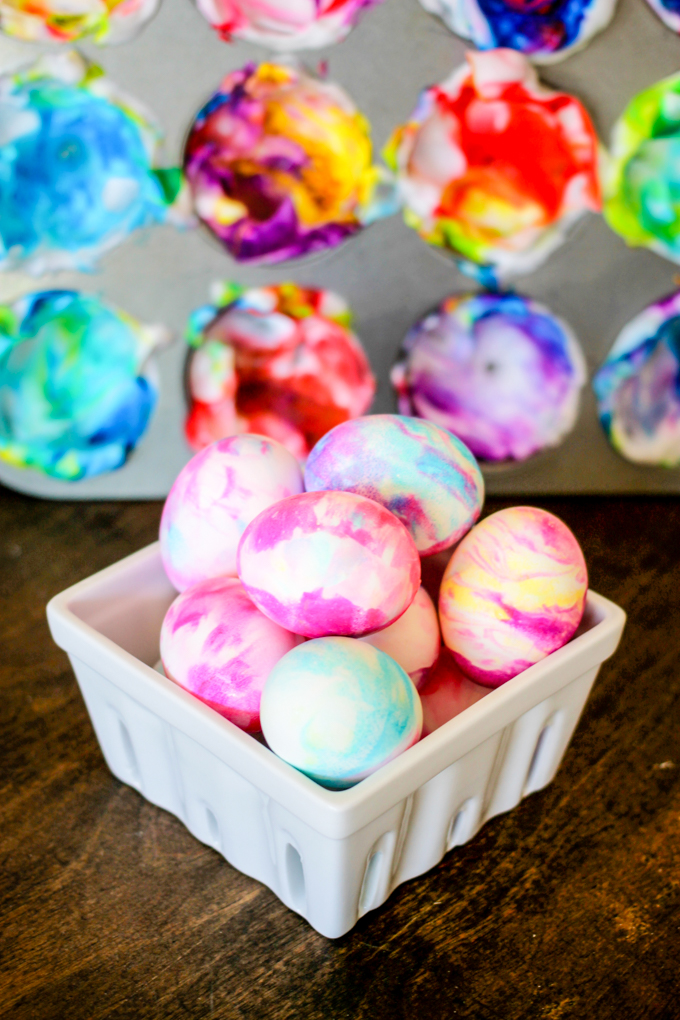 easter eggs decorated in a muffin tin with cool whip