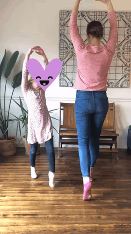 a mom and her daughter walk on their toes like a ballerina