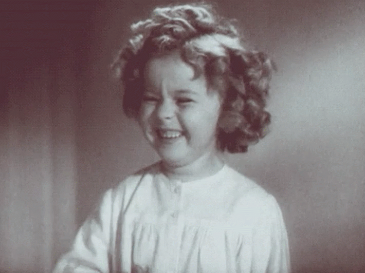 gif of shirley temple giggling
