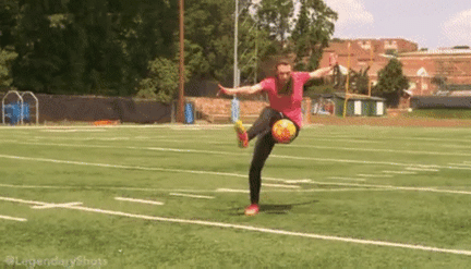 a woman practices tricks with a soccer ball