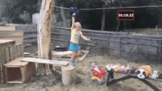a young girl uses a zipline in her back yard
