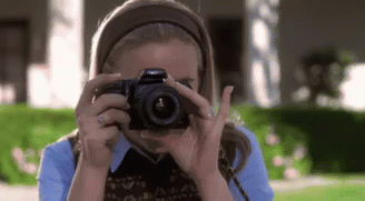 a woman uses a camera to take a picture