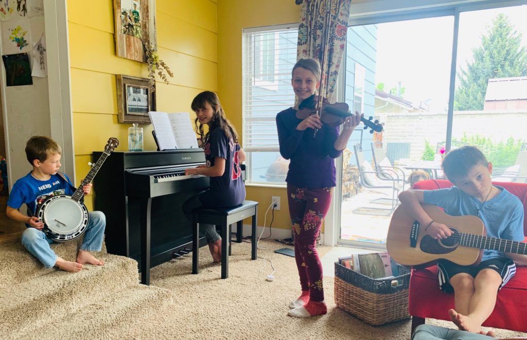 siblings practice playing music together