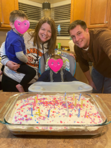 a mom celebrates her birthday with a cake and her family