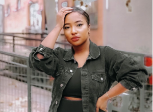 a young woman poses on the street