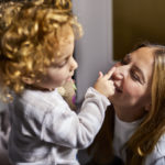 Girl touching her nanny's nose