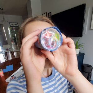 A girl looks through a DIY Kaleidoscope