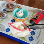 Homemade ice cream sundaes on a colorful tray.